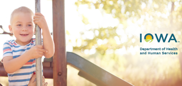 Smiling child playing on a play set